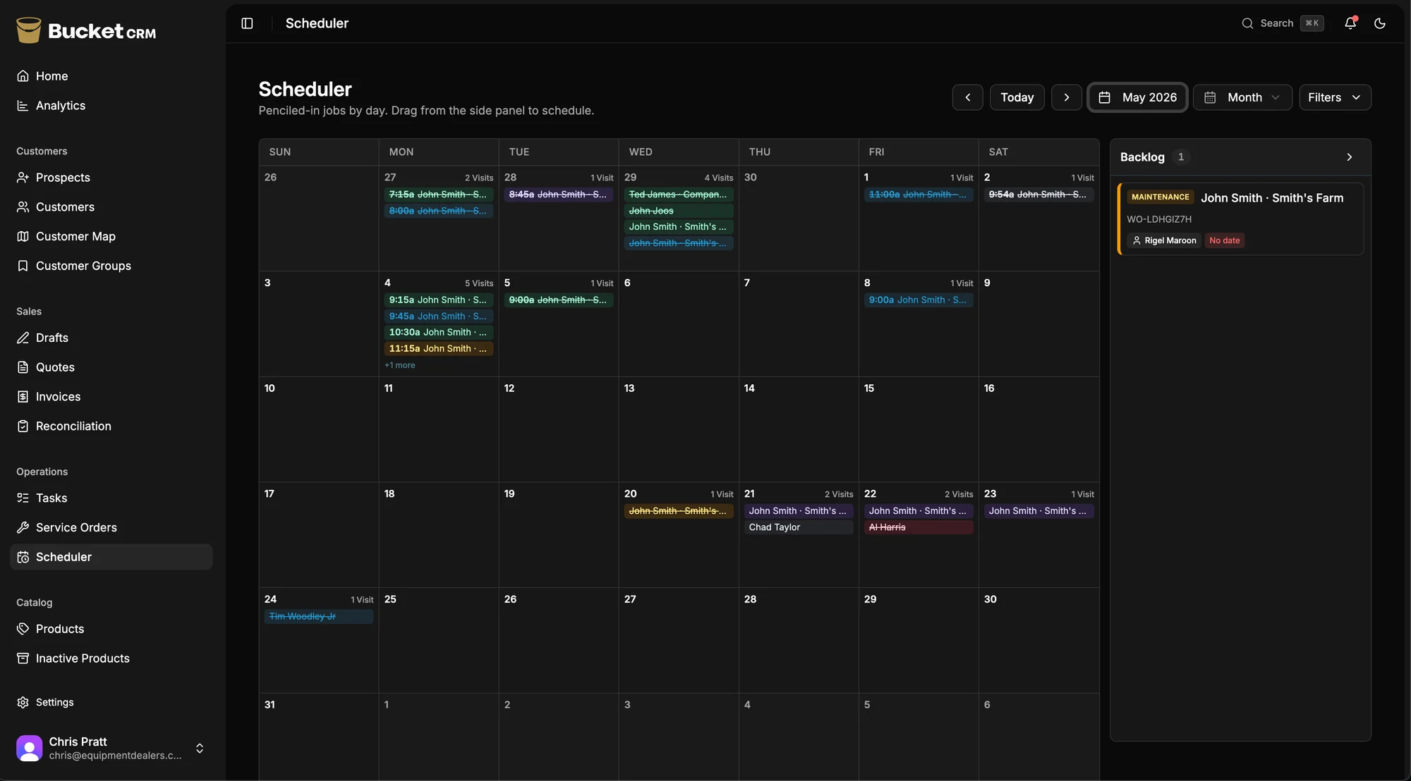 Bucket's scheduler — a month calendar of penciled-in service jobs per day, color-coded by technician, with an unscheduled-jobs backlog panel on the right.